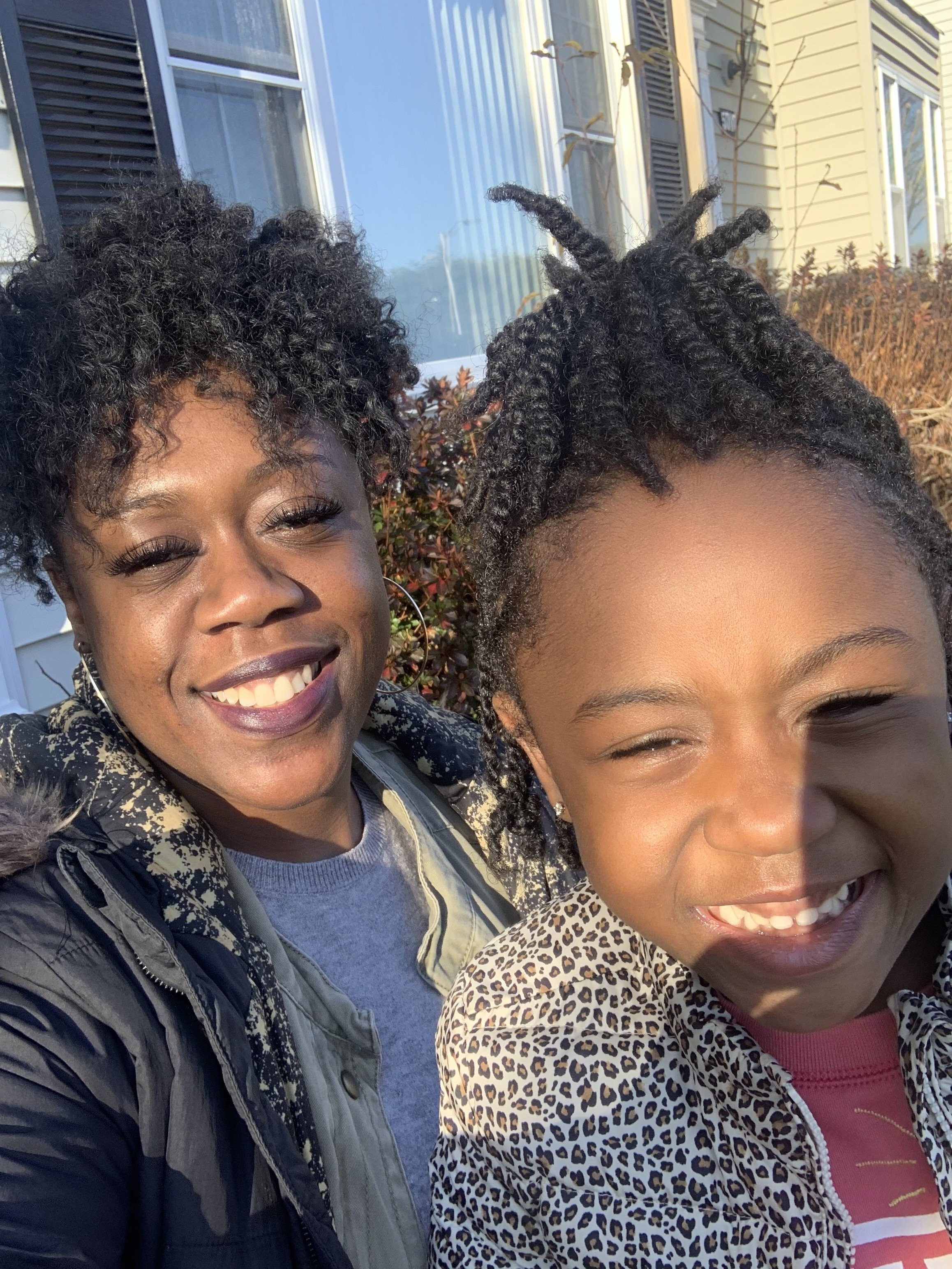 A mother and a daughter taking a selfie together.